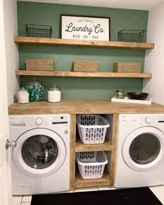 a washer and dryer in a small room with shelves above the washer