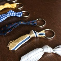 four different types of ties are on the table next to each other, including one with an umbrella