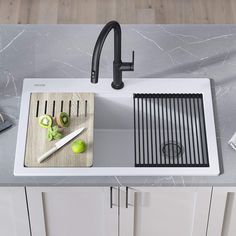 a kitchen sink with a cutting board and knifes on the counter next to it