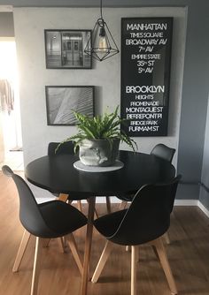 a dining room table with chairs and a potted plant