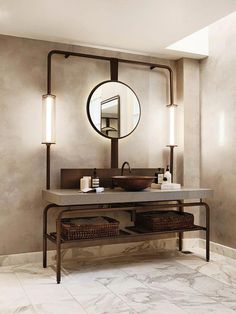 a bathroom with a sink, mirror and two wicker baskets