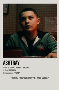 a young man sitting at a table in front of a poster with the caption ashtray