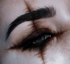 a close up of a person's face with blood on the nose and eyebrows