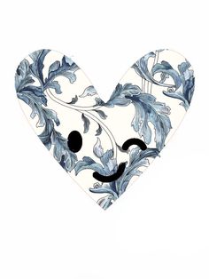 a heart shaped plate with blue and white designs on it