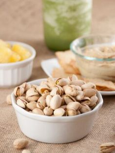 three bowls filled with food sitting on top of a table