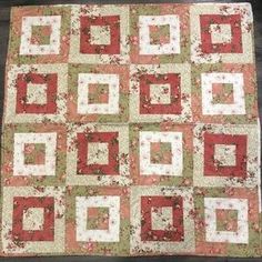 a red and white quilt with squares on it