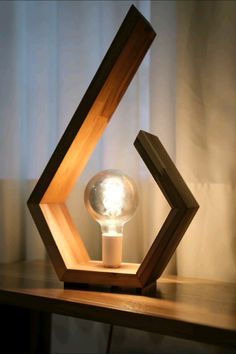 a wooden table with a light on it and a lamp in the shape of an octagon