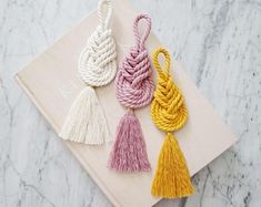 three tassels on top of a napkin with the words beautiful home design written below them