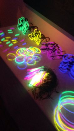 several different colored lights on a table with circles and rings in the middle, all lit up