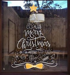 a glass window with a christmas tree drawn on it