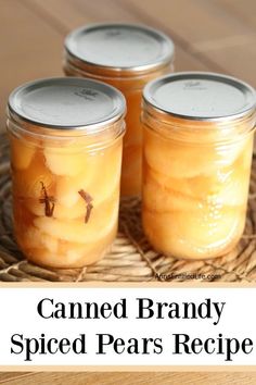 three jars filled with canned beans sitting on top of a wooden table next to a wicker basket