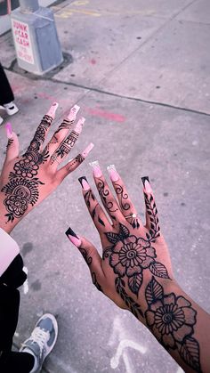 two hands with black and white designs on them