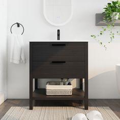 a bathroom with a sink, mirror and white slippers on the floor next to it