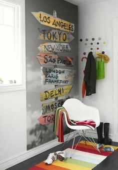 a white chair sitting in front of a wall with signs on it's side