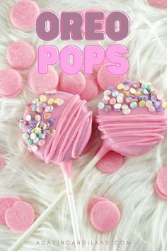 two pink lollipops with sprinkles on top and the words oreo pops above them