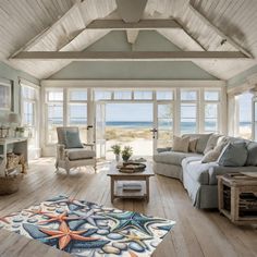 a living room filled with furniture and large windows