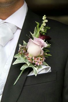 a man in a suit with a boutonniere on his lapel