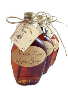 two bottles of maple syrup tied together with twine and paper tags that read vanilla bush maple syrup