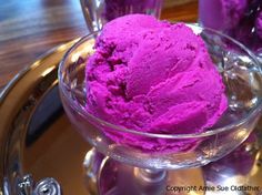 purple ice cream in a glass bowl on a tray