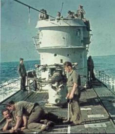 men are on the deck of a large ship