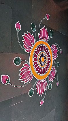 an artistic design on the side of a building with flowers and leaves painted on it