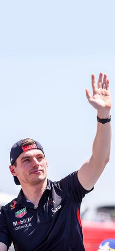 a man waves to the crowd at an event