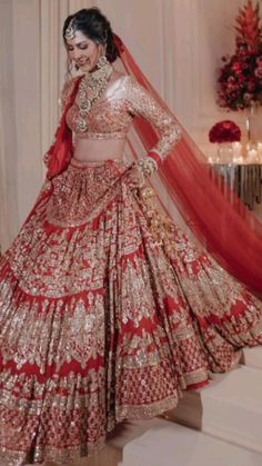 a woman in a red and gold bridal gown