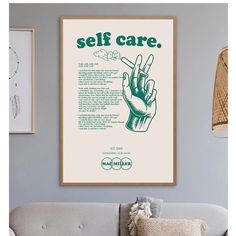 a living room with a couch and a poster on the wall above it that says self care