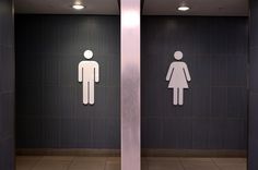 two urinals with men and women symbols on them