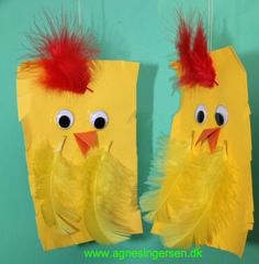 two yellow paper bags with red hair and eyes are hanging on the wall next to each other