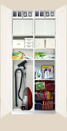 an open white closet with many items in it and storage bins on the shelves