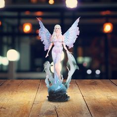 a figurine is on top of a wooden table with lights in the background