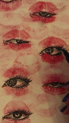 someone is drawing on paper with their eyes and lips