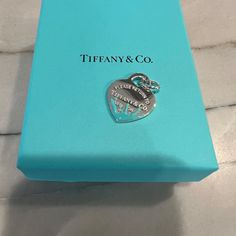 Brand New And Never Used Tiffany And Co. Blue Splash Charm. Discontinued And No Longer Being Sold. The Charm Is Crafted Of 925 Sterling Silver And Features A Heart Tag Charm Accented With Blue Enamel. Guaranteed To Be Authentic And Comes With Original Pouch And Box. Will Be Tied With The Signature Tiffany Bow. This Would Make An Amazing Gift! Return To Tiffany, Heart Tag, Tiffany And Co, Tiffany Blue, Tiffany & Co., A Heart, Blue And Silver, Best Gifts, 925 Sterling Silver