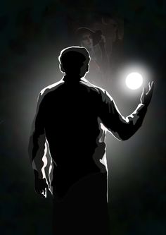 a man standing in the dark holding a light