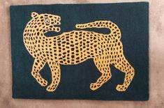 a black and yellow rug with a cheetah on it