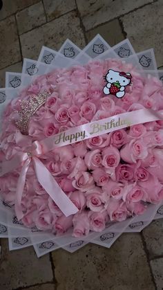 a bouquet of pink roses with a hello kitty sticker on the top and happy birthday written on it