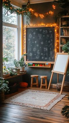 a room with a chalkboard, potted plants and two stools in front of it