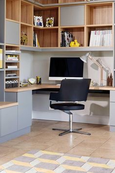 a computer desk sitting in front of a book shelf