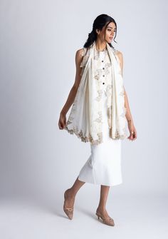 This classic ivory scarf is crafted from a luxurious blend of wool and silk, providing a soft and cozy feel. It features an exquisitely handcrafted triple-colored scalloped lace border in the perfect blend of earthy tones with an interplay between beige, natural, and alabaster. This versatile accessory is perfect for elevating any ensemble, making it a timeless must-have addition to any wardrobe, ideal for any occasion. White Festive Pashmina Shawl, White Pashmina Shawl For Festive Occasions, Festive White Pashmina Shawl, White Shawl With Embroidered Border, Elegant Pashmina Shawl With Embroidered Border For Wedding, Elegant Beige Scarves For Festive Season, Elegant Cream Scarves For Festive Season, Elegant Cream Shawl Dupatta, Elegant Beige Festive Scarves