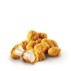 chicken nuggets are piled on top of each other in front of a white background