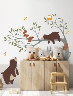 there is a bear and other animals on the tree wall decal in this children's room