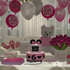 a table topped with a cake and balloons