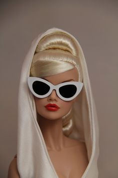 a mannequin head wearing sunglasses and a white dress with long blonde hair in the shape of a wig