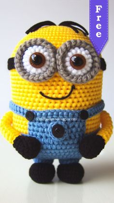 a crocheted minion with big eyes and glasses on it's face