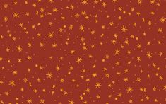 an orange and yellow star pattern on a red background with small white stars in the center