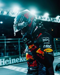 a man in a racing suit and helmet