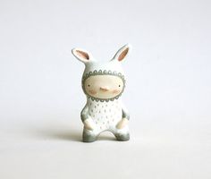 a small ceramic animal sitting on top of a white table