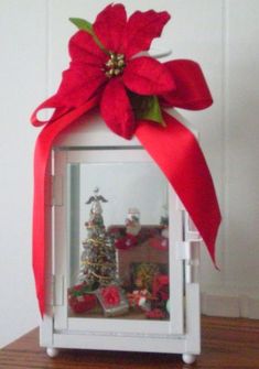 a christmas display case with a poinsettia on top