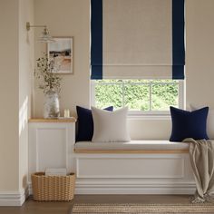 a white window seat with blue and white pillows